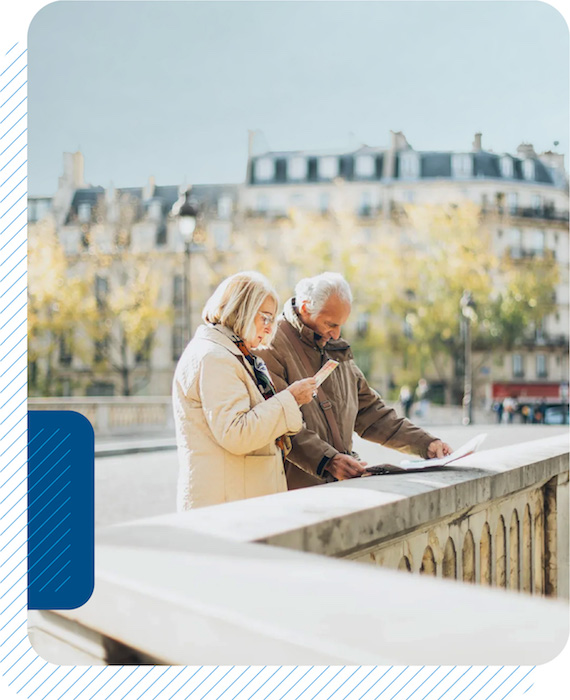 Older couple looking at a map on a bridge